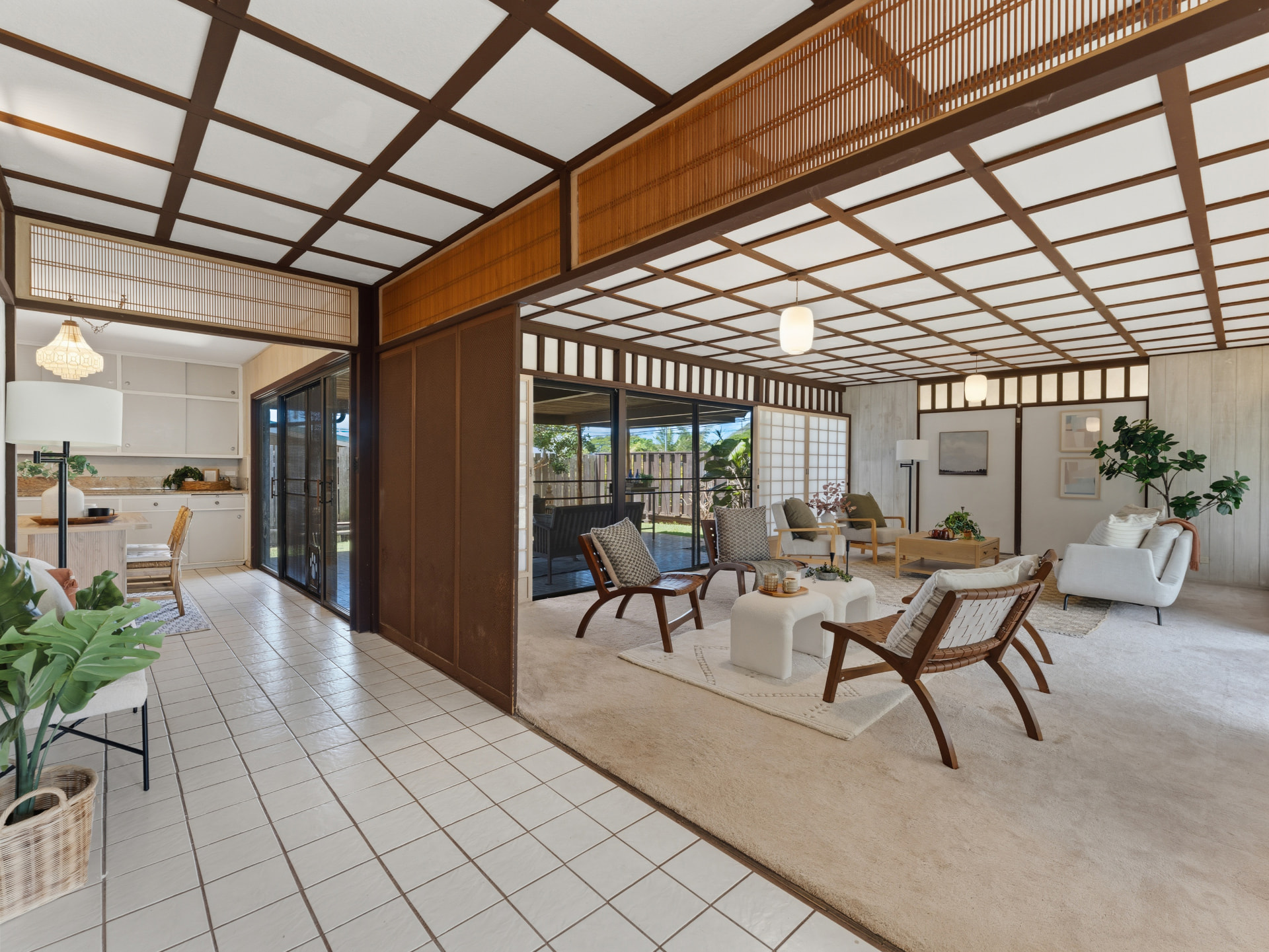 Living room looking toward the kitchen with wood screens and lanai access