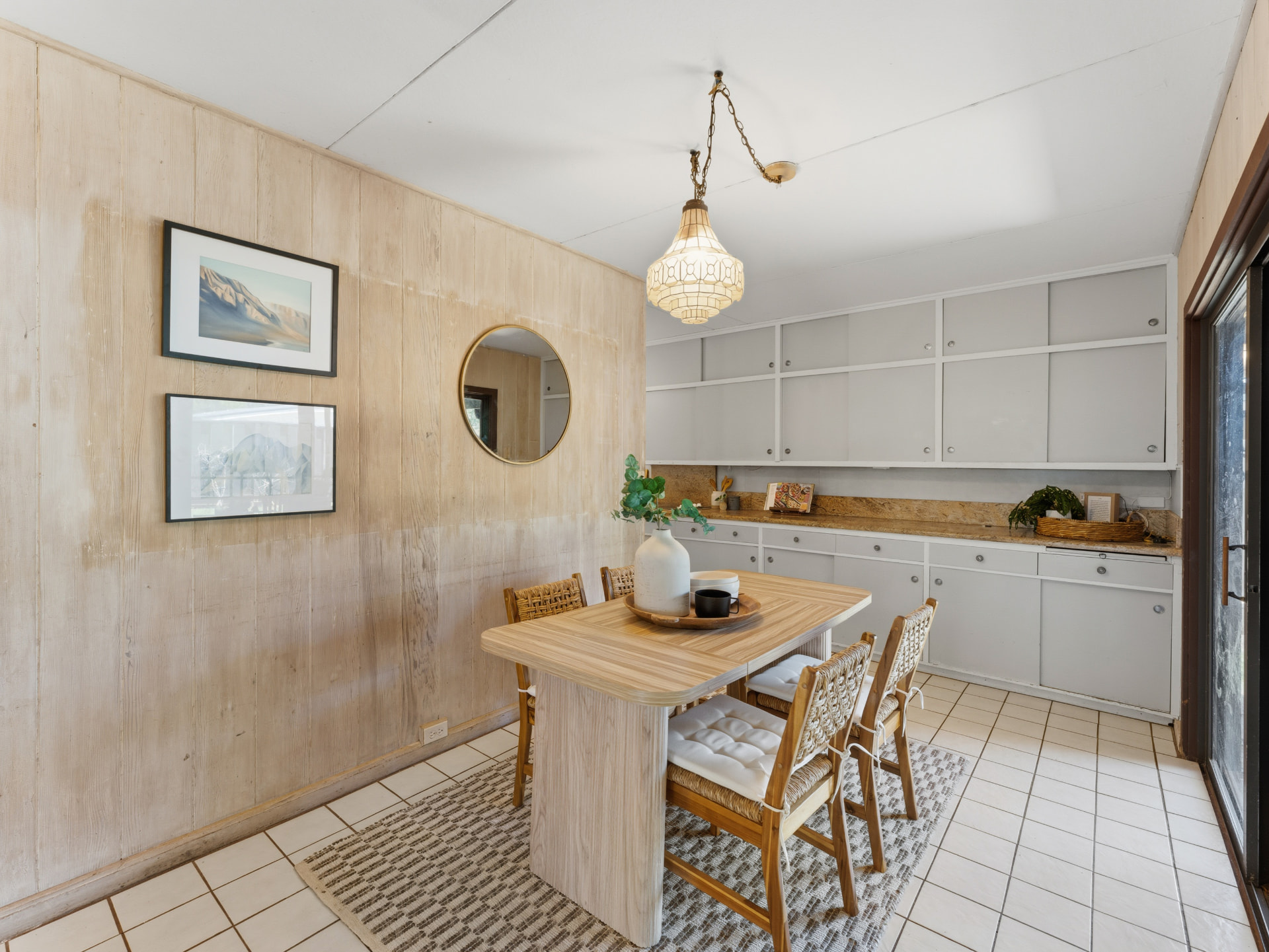 Dining area with built-in cabinetry, tile floor, and pendant light